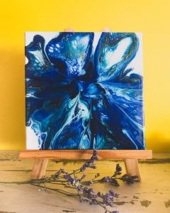 Tableau abstrait peinture fluide bleu posé sur un chevalet